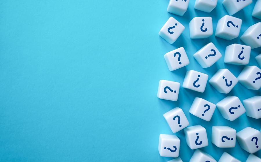 Cubes with question marks on against blue background