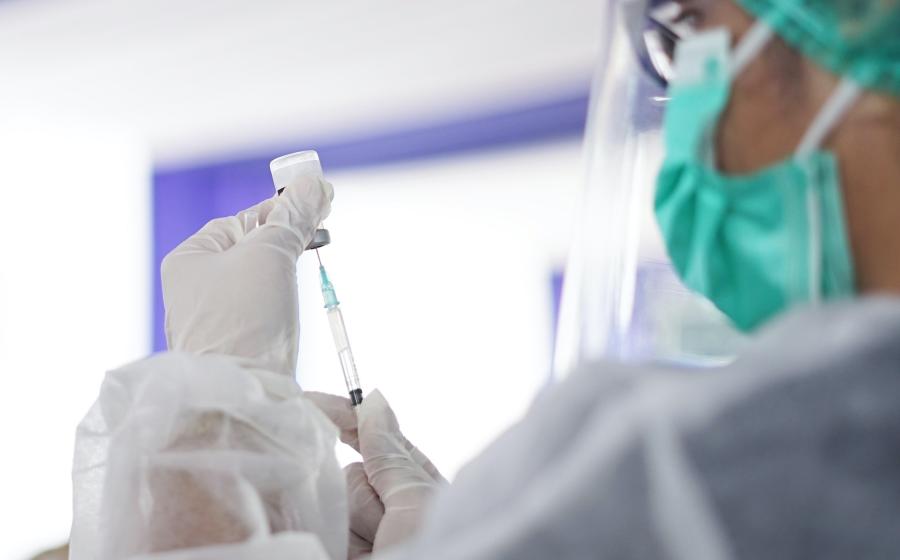 Healthcare worker with vial and needle vaccine