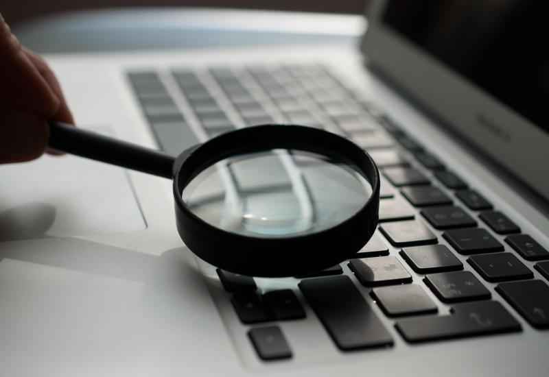 Magnifying glass resting on computer