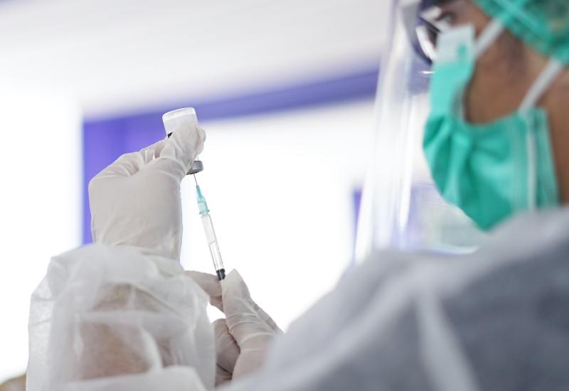 Healthcare worker with vial and needle vaccine